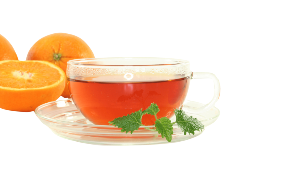 An illustrative image of a clear glass tea cup and saucer with orange tea and mint leaf