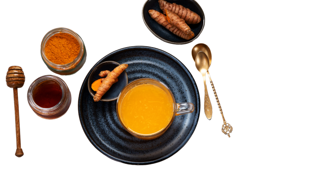 An illustrative image of turmeric tea in a cup and saucer on a white background with turmeric root, powder, honey and golden spoons