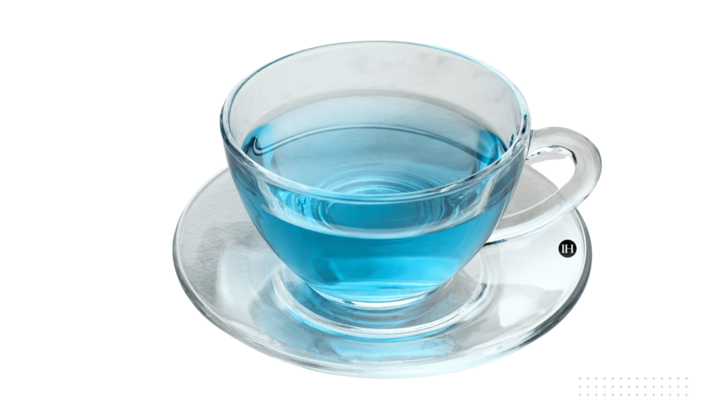 An illustrative example of a clear glass cup and saucer with blue herbal tea