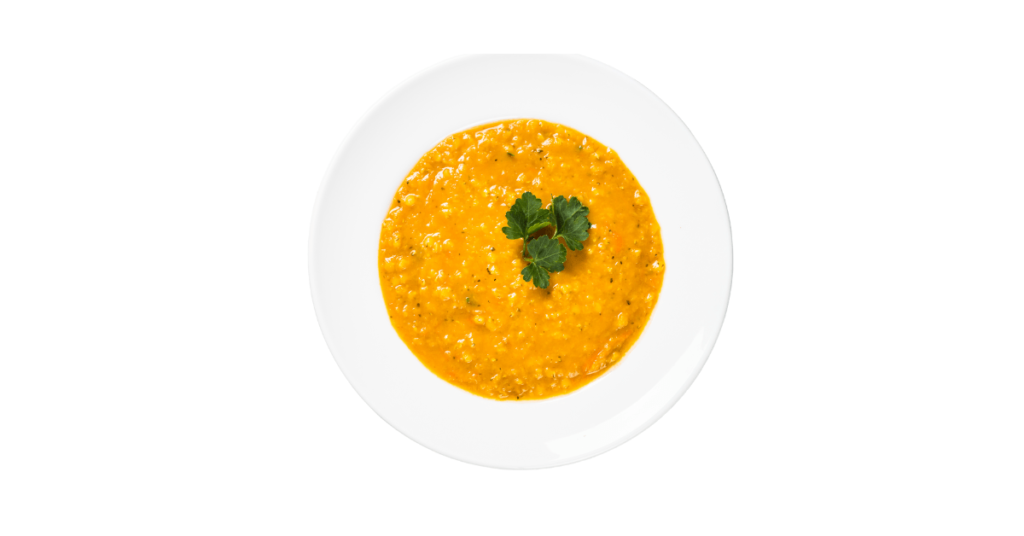 A round bowl of organic Ayurvedic Khichdi made from red lentils, turmeric, rice grain